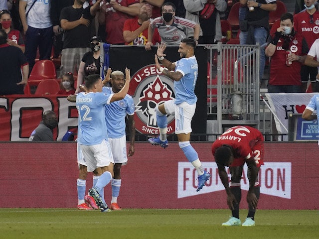 New York City FC forward Valentin Castellanos (11) celebrates a goal from forward Santiago Rodriguez (not shown) against Toronto FC with defender Malte Amundsen (12) and forward Thiago (8) during the first half at BMO Field on August 7, 2021