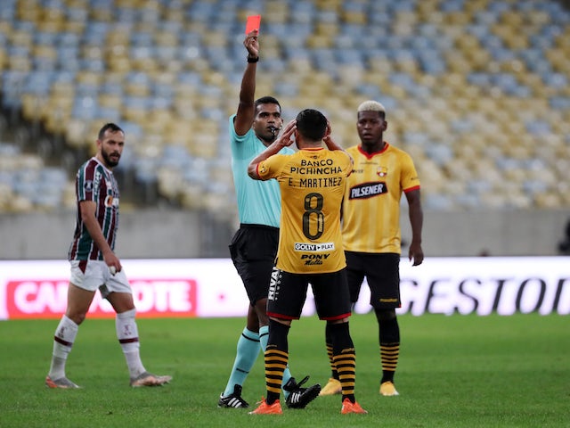 Barcelona SC's Leandro Martinez is shown a red card by referee Alexis Molina on August 13, 2021