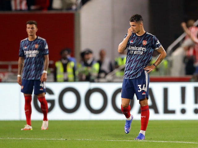 Arsenal's Granit Xhaka and Ben White look dejected after Brentford's Christian Norgaard scored their second goal on August 13, 2021