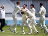 England's Mark Wood celebrates with Joe Root after taking the wicket of India's Rohit Sharma on August 15, 2021