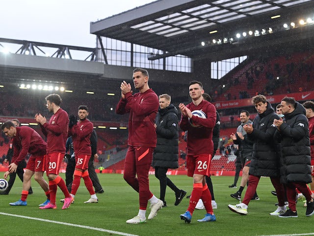 Liverpool's Andrew Robertson and Jordan Henderson celebrate after winning the match and qualifying for the UEFA Champions League in May 2021