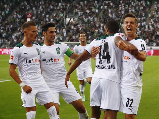 Borussia Monchengladbach's Alassane Plea celebrates scoring their first goal with teammates on August 13, 2021