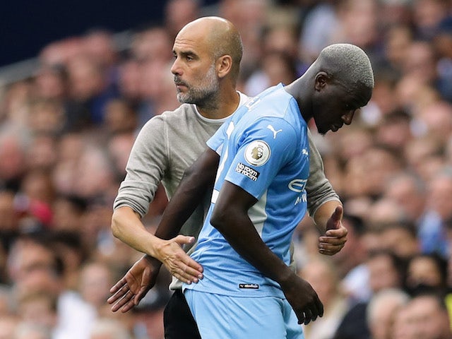 Manchester City's Benjamin Mendy with manager Pep Guardiola after being substituted on August 15, 2021
