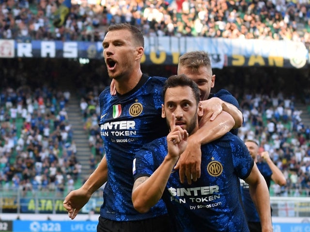 Inter Milan's Hakan Calhanoglu celebrates scoring their second goal with teammates on August 21, 2021