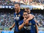 Inter Milan's Hakan Calhanoglu celebrates scoring their second goal with teammates on August 21, 2021
