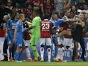 Pitch invaders clash with players as the game between Marseille and Nice is interrupted on August 22, 2021