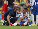 Brighton & Hove Albion's Neal Maupay receives medical attention after sustaining an injury on August 21, 2021