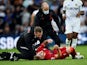 Liverpool's Harvey Elliott reacts as he receives medical attention after sustaining an injury