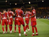 Lyon's Moussa Dembele celebrates scoring their first goal with teammates in August 2021
