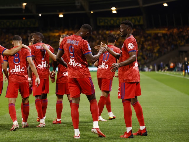 Lyon's Moussa Dembele celebrates scoring their first goal with teammates in August 2021