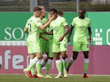 Wolfsburg's Lukas Nmecha celebrates scoring their first goal with teammates on September 11, 2021