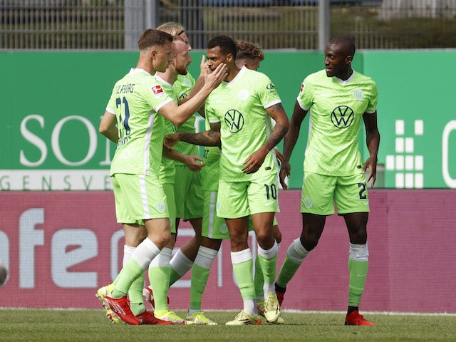 Wolfsburg's Lukas Nmecha celebrates scoring their first goal with teammates on September 11, 2021