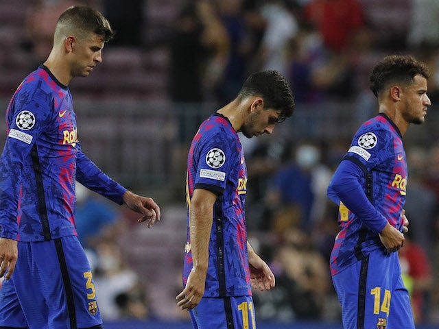 Barcelona's Gerard Pique, Yusuf Demir and Philippe Coutinho look dejected after the match on September 14, 2021