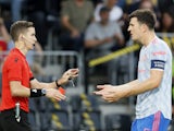 Manchester United's Harry Maguire speaks to referee Francois Letexier in the Champions League on September 14, 2021