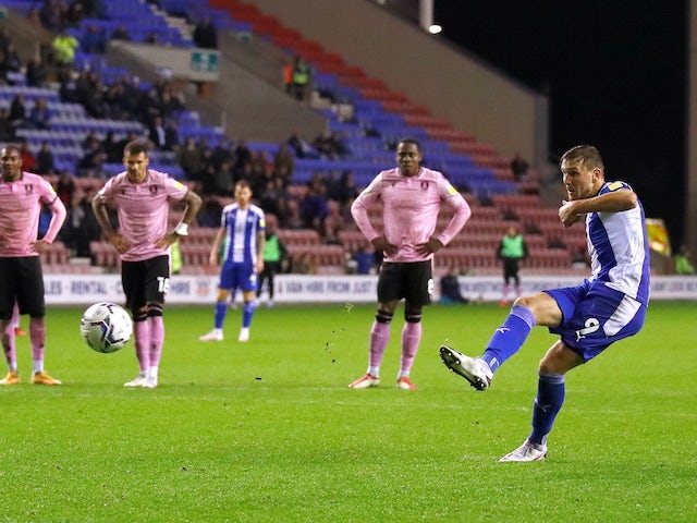 Wigan Athletic's Charlie Wyke scores their first goal from the penalty spot on September 28, 2021
