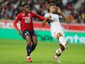 Olympique de Marseille's William Saliba in action with Lille's Jonathan David in October 2021