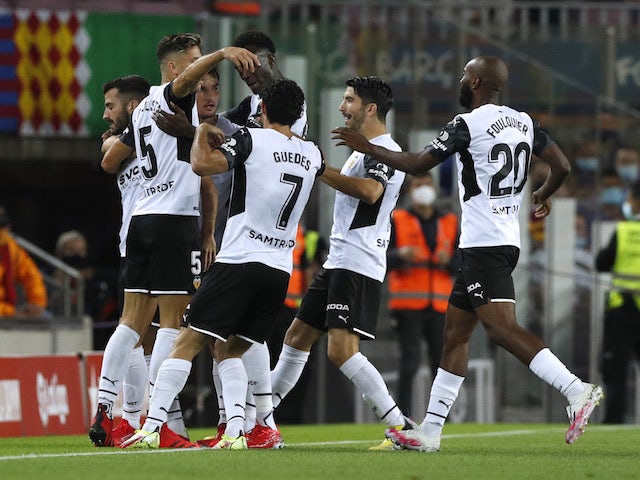 Valencia's Jose Gaya celebrates scoring their first goal with teammates on October 17, 2021