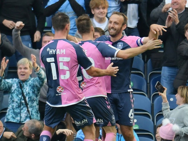 Coventry City's Liam Kelly celebrates their second goal with teammates on October 16, 2021