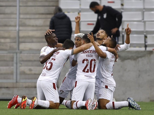 Fluminense players celebrate after Athletico Paranaense's Ze Ivaldo scores an own goal and Fluminense's first on October 17, 2021