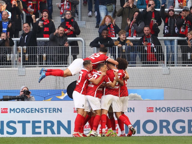 SC Freiburg's Jeong Woo-yeong celebrates scoring their first goal with teammates on October 16, 2021