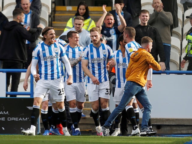 Huddersfield Town's Tom Lees celebrates scoring their first goal with teammates on October 16, 2021