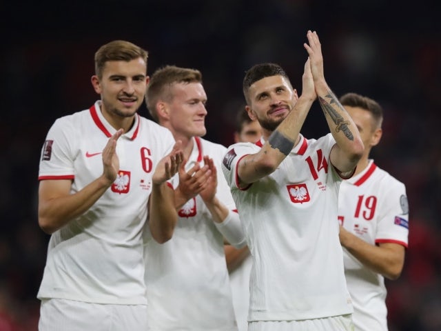 Poland's Mateusz Klich and Michal Helik applaud fans after the match on October 12, 2021