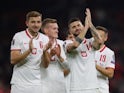 Poland's Mateusz Klich and Michal Helik applaud fans after the match on October 12, 2021