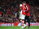 Arsenal's Bukayo Saka receives medical attention after sustaining an injury on October 18, 2021
