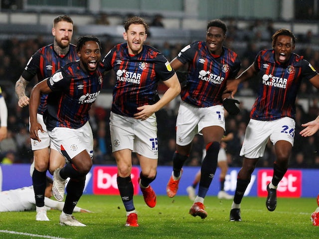 Luton Town's Fred Onyedinma celebrates scoring their first goal with teammates on October 19, 2021