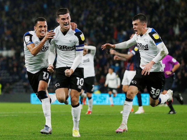Derby County's Tom Lawrence celebrates scoring their first goal with teammates on October 19, 2021