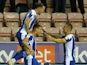 Wigan Athletic's Charlie Wyke celebrates scoring their first goal with teammates on October 19, 2021