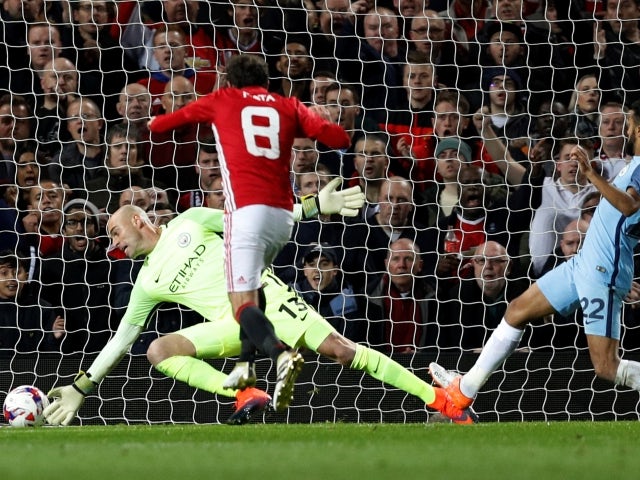 Manchester United's Juan Mata scores past Manchester City's Willy Caballero on October 26, 2016
