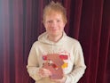 Ed Sheeran poses with his number one award for Equals on November 5, 2021