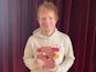 Ed Sheeran poses with his number one award for Equals on November 5, 2021