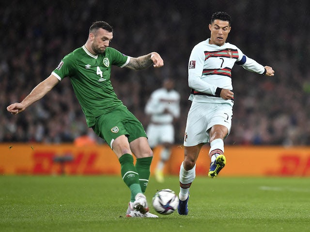 Shane Duffy from the Republic of Ireland in action with Portuguese Cristiano Ronaldo on 11 November 2021