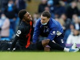 Everton's Demarai Gray receives medical attention after sustaining an injury