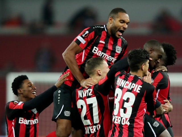 Bayer Leverkusen's Jonathan Tah and Moussa Diaby celebrate with teammates on November 4, 2021