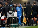 Olympique de Marseille's Dimitri Payet walks off the pitch injured after being hit by a water bottle thrown by a fan on November 21, 2021