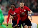 Lille's Jonathan David celebrates scoring their first goal with Burak Yilmaz on November 23, 2021