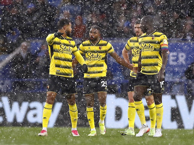 Watford's Emmanuel Dennis and teammates react while snow falls during the match on November 28, 2021