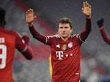 Bayern Munich's Thomas Muller celebrates their third goal scored by Jamal Musiala on December 8, 2021