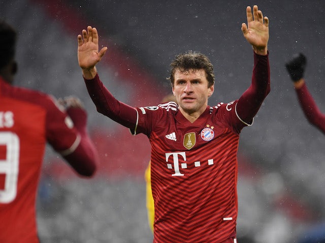 Bayern Munich's Thomas Muller celebrates their third goal scored by Jamal Musiala on December 8, 2021