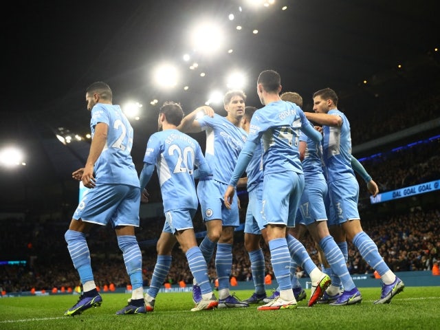 Manchester City players celebrate after scoring against Leeds United on 14 December 2021