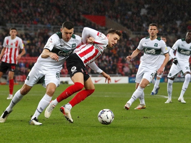 Sunderland's Dan Neil in action with Plymouth's James Wilson, December 11, 2021