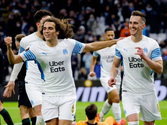 Marseille's Arkadiusz Milik celebrates scoring their first goal with Matteo Guendouzi on December 9, 2021