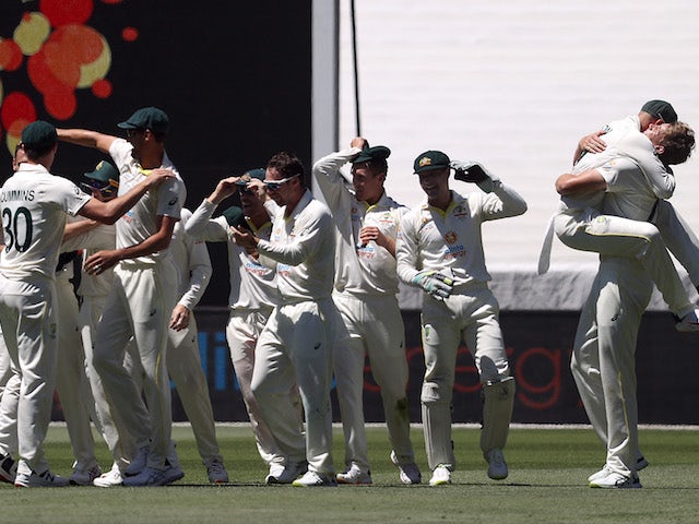 Australia players celebrate winning the match and retaining the Ashes on December 28, 2021