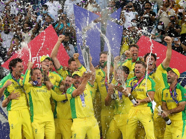 Australia captain Aaron Finch celebrates with the trophy and teammates after winning the ICC Men's T20 World Cup