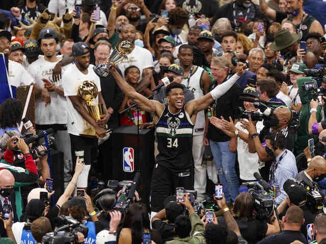 ilwaukee Bucks forward Giannis Antetokounmpo (34) celebrates with the NBA Finals MVP Trophy following the game against the Phoenix Suns following game six of the 2021 NBA Finals at Fiserv Forum in July 2021