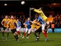 Cambridge United's Dimitar Mitov in action with Portsmouth's Sean Raggett on January 3, 2022