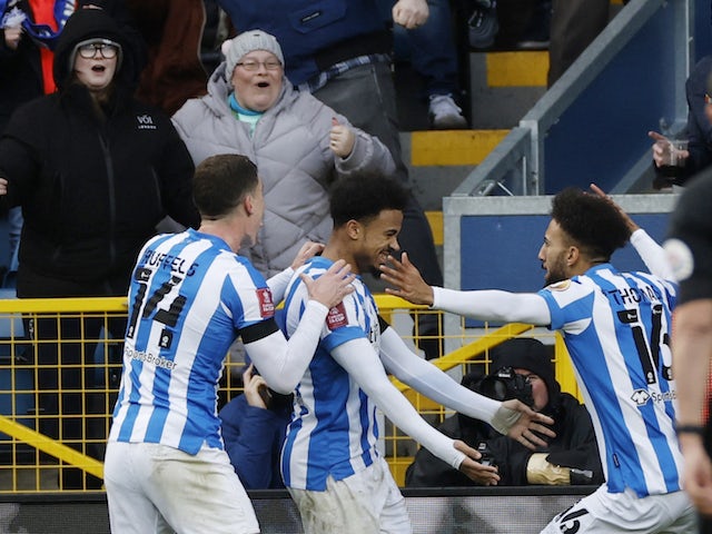 Huddersfield Town's Josh Koroma celebrates scoring their first goal with teammates on January 8, 2022